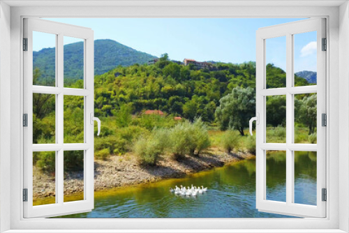 Fototapeta Naklejka Na Ścianę Okno 3D - Aerial view over Rijeka Crnojevica from the Pavlova Strana viewpoint, Lake Skadar, Montenegro, Clean river and huge mountains, Water is covered by waterlily. Great location for holiday.