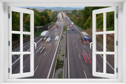 Fototapeta Naklejka Na Ścianę Okno 3D - Long exposure photo of traffic with blurred traces from cars, top view. road, cars, blurred traffic, evening, top view. Highway at evening, blue hour illuminated by the traffic of cars