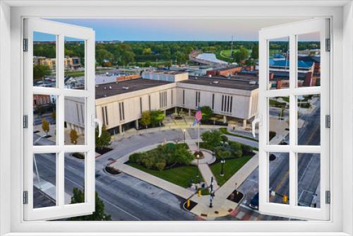 Fototapeta Naklejka Na Ścianę Okno 3D - Delaware County Court Administration building with flapping American flag aerial at dawn, Muncie, IN