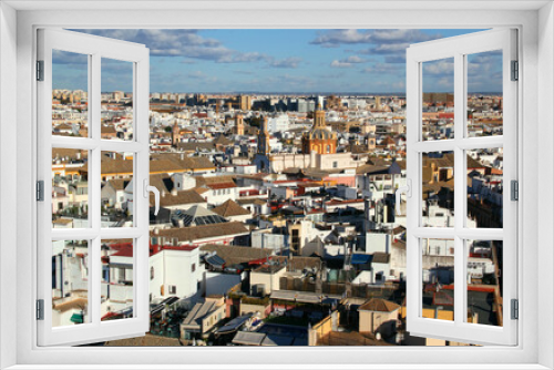 Fototapeta Naklejka Na Ścianę Okno 3D - Panoramic view of the city of Seville (Andalusia region, southern Spain) with snow-white houses and churches against a blue sky with clouds