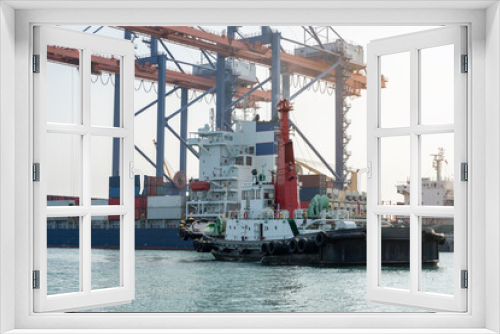 Fototapeta Naklejka Na Ścianę Okno 3D - Big crane loading cargo container from truck to container ship in the international terminal logistic sea port concept freight shipping by ship, forwarder mast shipping