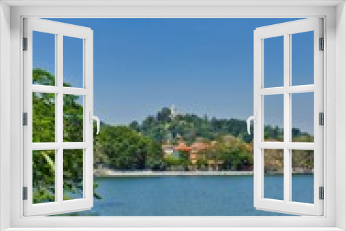 Fototapeta Naklejka Na Ścianę Okno 3D - KANDY, SRI LANKA - FEBRUARY 10, 2021: View on Kandy lake and big Buddha on top of the hill. Kandy is home of The Temple of the Tooth Relic, one of the most sacred Buddhist places of worship. 