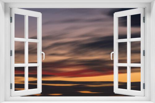 Fototapeta Naklejka Na Ścianę Okno 3D - Peaceful Dusk: A Long Exposure of Clouds at Sunset