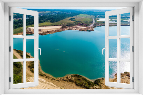 Fototapeta Naklejka Na Ścianę Okno 3D - A flooded sand pit with turquoise water. View from high altitude