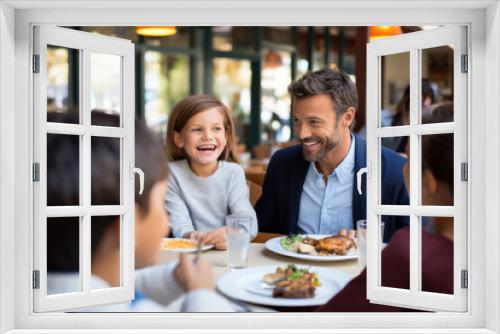 A joyful family, a father and daughters, shares a meal, bonding and smiling together on a terrace.