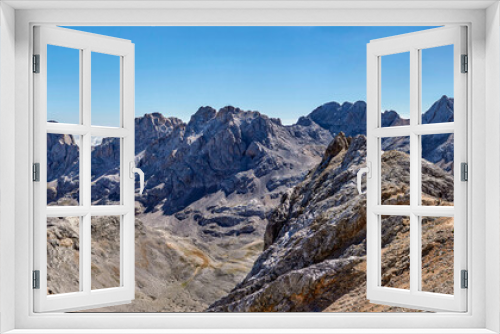 Fototapeta Naklejka Na Ścianę Okno 3D - Mountain landscape in Fuentede, Naranjo de Bulnes on the left and hikers on the right. Picos de Europa National Park, Spain. High quality 4k images