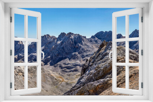 Mountain landscape in Fuentede, Naranjo de Bulnes on the left and hikers on the right. Picos de Europa National Park, Spain. High quality 4k images