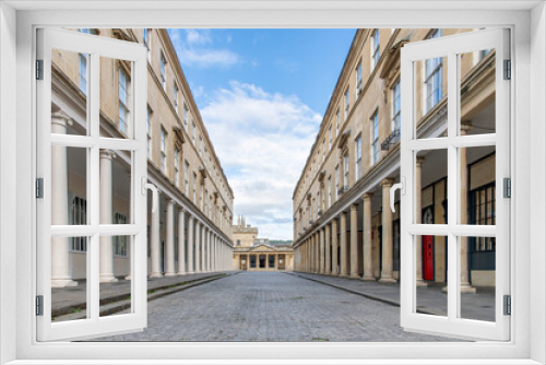 Fototapeta Naklejka Na Ścianę Okno 3D - View through Bath Street, Bath, Somerset, UK with buildings with typical Georgian architecture and columns and entrance to ancient Roman Baths at end of street