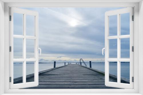 Fototapeta Naklejka Na Ścianę Okno 3D - Wooden pier or dock on sea water in morning light