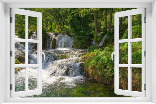 Fototapeta Naklejka Na Ścianę Okno 3D - A small waterfall in a stream which runs through the village of Martin Brod in Una-Sana Canton, Federation of Bosnia and Herzegovina. Located within the Una National Park. Early September