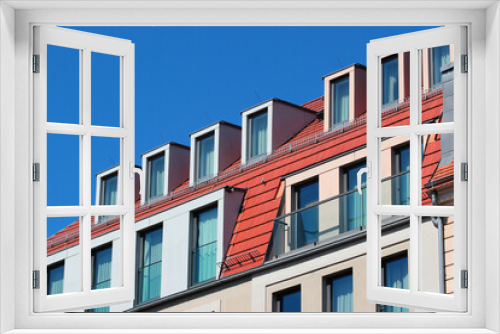 Fototapeta Naklejka Na Ścianę Okno 3D - Modern attic windows on red roofs against blue sky background