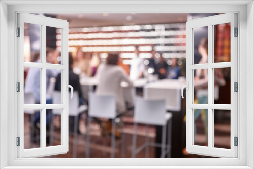 Out of focus effect. Restaurant interior with people. Seated persons