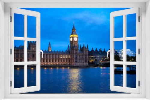 Fototapeta Naklejka Na Ścianę Okno 3D - Exterior view of majestic facade of royal palace located near Thames river next to Big Ben against blue sky at evening time in London