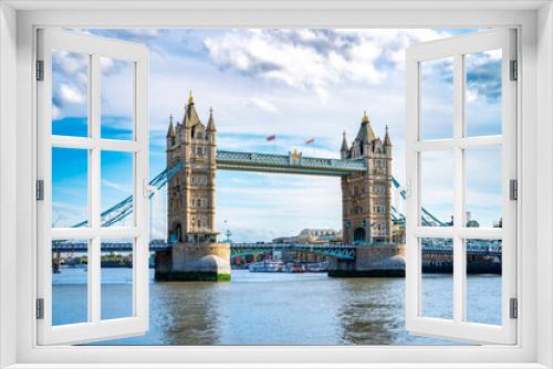 Fototapeta Naklejka Na Ścianę Okno 3D - Amazing view of Tower bridge with flags over rippling river against cloudy blue sky in London