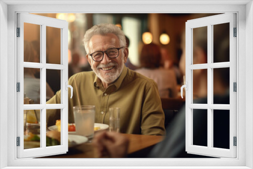 Elderly man enjoying meal and conversation at restaurant. Social interaction and lifestyle.