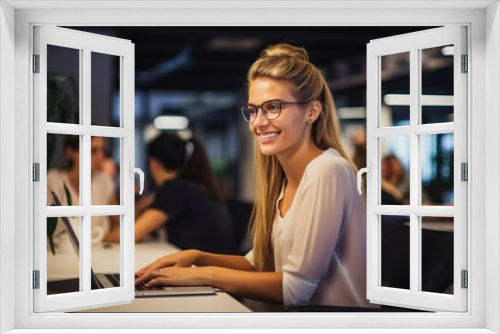 Young and beautiful woman working with laptop in office