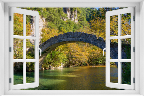 Fototapeta Naklejka Na Ścianę Okno 3D - Stone Bridge of Kleidonia. This stone bridge with its unique arch is situated near the village of Kleidonia at the end of Vikos Gorge in Zagori, Epirus, Greece. Old Arch Bridge over Voidomatis River.