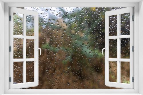 Fototapeta Naklejka Na Ścianę Okno 3D - rain drops sliding at car window glass at rainy day from flat angle