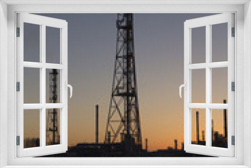 Fototapeta Naklejka Na Ścianę Okno 3D - An oil refinery at sunset
