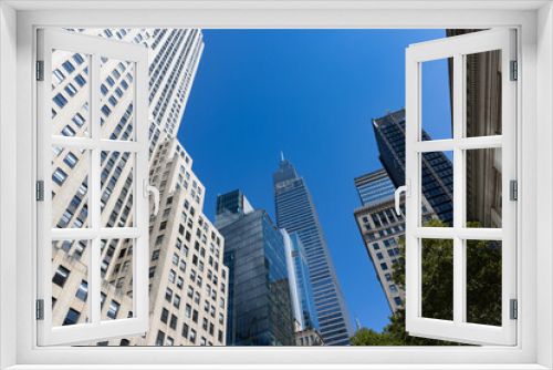 Fototapeta Naklejka Na Ścianę Okno 3D - Beautiful Buildings and Skyscrapers with a Blue Sky in Midtown Manhattan of New York City