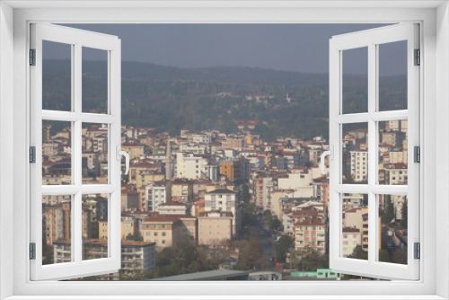 The view from the skyscraper window to the Asian part of Istanbul. City development. On the horizon of mountains and hills.