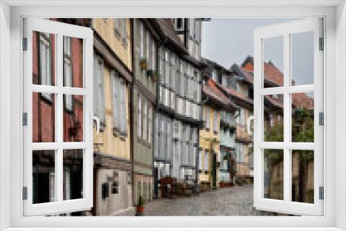Fototapeta Naklejka Na Ścianę Okno 3D - Quedlinburg in Germany, narrow street with historic houses.