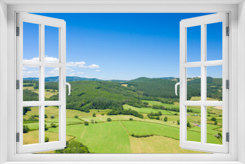 Fototapeta Naklejka Na Ścianę Okno 3D - The countryside with its forests and green fields in Europe, France, Burgundy, Nievre, towards Chateau Chinon, in summer, on a sunny day.