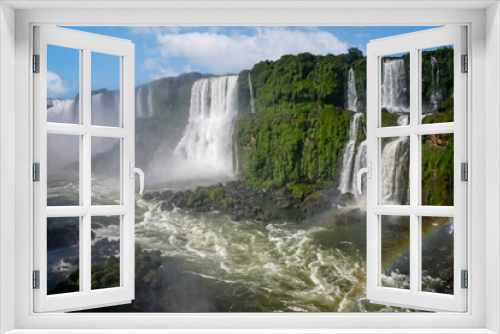 Fototapeta Naklejka Na Ścianę Okno 3D - Water cascading over the Iguacu falls with rainbow in Brazil
