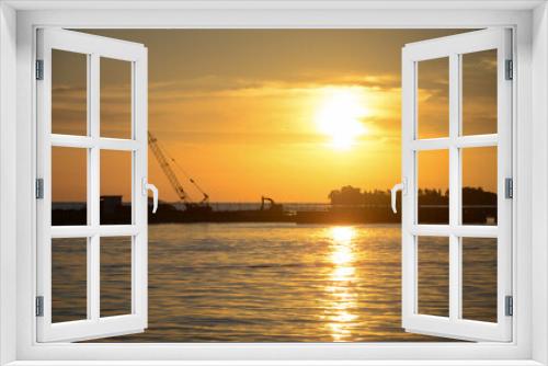 Fototapeta Naklejka Na Ścianę Okno 3D - Silhouette construction boat and cranes setting in marine area to contract export pipeline business under to sea with beautiful sunset sky background.