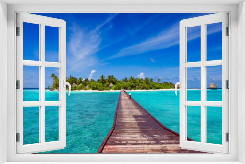 Fototapeta Naklejka Na Ścianę Okno 3D - Jetty over blue ocean leading to sandy beach of tropical island, beautiful sky, green palm trees, maldives islands