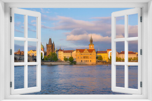 Fototapeta Naklejka Na Ścianę Okno 3D - View of old town with Charles Bridge (Karluv Most) on Vltava river and Old Town Bridge Tower, famous tourist destination in Prague, Czech Republic (Czechia), at sunset