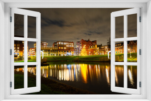 Fototapeta Naklejka Na Ścianę Okno 3D - Scenic night view of illuminated buildings in the centre of the town of Waddinxveen, The Netherlands.