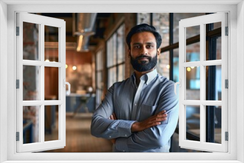 Confident happy successful ceo financial manager. Bearded indian businessman looking at camera standing in modern office with arms crossed. Handsome classy corporation owner. Generative AI 