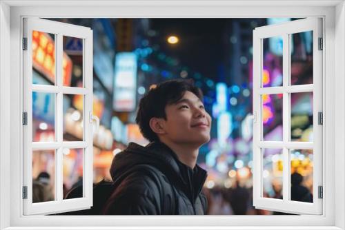 Asian young man exploring a vibrant city street at night