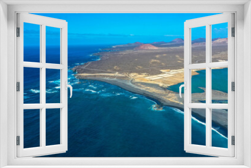 Fototapeta Naklejka Na Ścianę Okno 3D - Drone panoramic view of Playa del Janubio in Lanzarote with the volcanic landscape in the background  with turquoise sea and big waves. Nature and tourism.  Canary Islands, Spain.