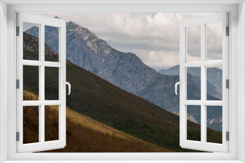 Fototapeta Naklejka Na Ścianę Okno 3D - dramatic mountain view with sky, clouds and rugged peaks in a mountainous landscape in the fynbos cape mountains of South Africa