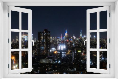 Fototapeta Naklejka Na Ścianę Okno 3D - Aerial View of Manhattan Architecture at Night. Night Photo of Financial Business District from a Helicopter. Scenery of Historic Office Towers, Illuminated Skyscrapers
