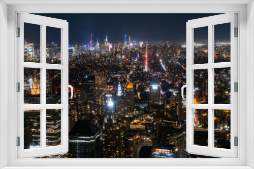 Fototapeta Naklejka Na Ścianę Okno 3D - Night Aerial Photo with New York City Skyscrapers with Lights in Office Rooms Inside. Helicopter View View Capturing Panorama of Manhattan