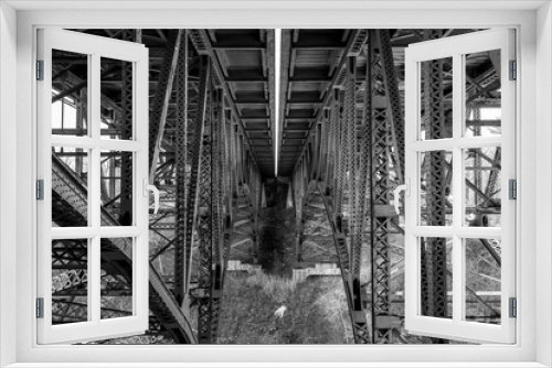 Fototapeta Naklejka Na Ścianę Okno 3D - Geometric view of trestles under overpass in black and white