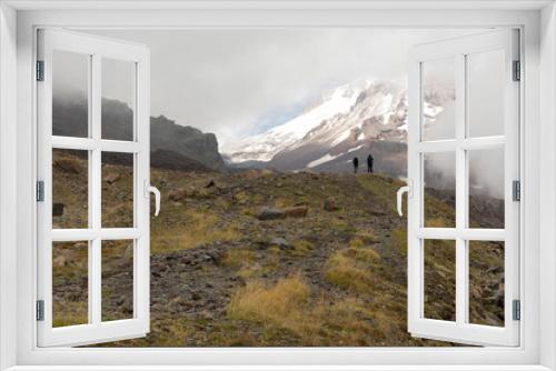 Fototapeta Naklejka Na Ścianę Okno 3D - Couple hiking on mountain in Georgia Caucasus muntains on summer day with peaks and snow