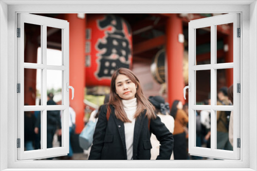 Tourist woman visit Sensoji Temple or Asakusa Kannon Temple is a Buddhist temple located in Asakusa, Tokyo Japan. Japanese sentence on red lantern means Thunder gate.