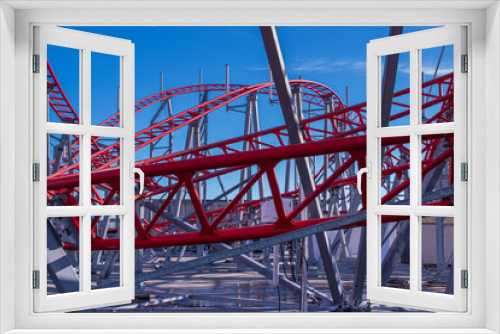 Fototapeta Naklejka Na Ścianę Okno 3D - Red rails of a roller coaster against a deep blue sky