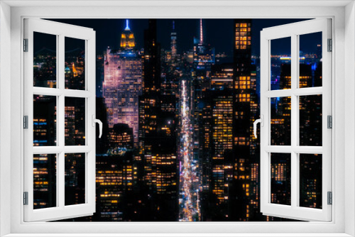 Fototapeta Naklejka Na Ścianę Okno 3D - Scenic Aerial New York City View of Downtown Manhattan Architecture. Panoramic Night Photo of the Business District from a Helicopter. Cityscape with Office Buildings and Busy Traffic on Streets