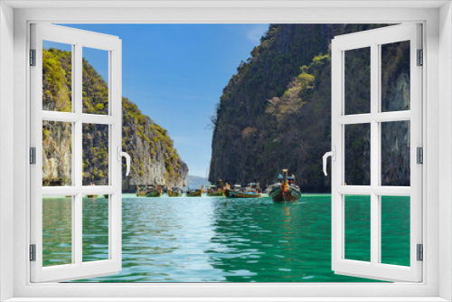 Fototapeta Naklejka Na Ścianę Okno 3D - Many fishing boat with tourists in the beautiful crystal clear water at Pileh Lagoon, Krabi, Southern of Thailand, on May 30,2023 in Phi Phi National Park, Krabi Province Thailand