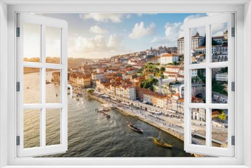 Fototapeta Naklejka Na Ścianę Okno 3D - Panoramic view of the city of Oporto during sunset. Porto skyline. Magnificent sunset over downtown Porto and the Douro river, Portugal. The Dom Luis I bridge is a popular tourist spot.