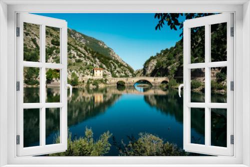 Fototapeta Naklejka Na Ścianę Okno 3D - Beautiful calm lake with bridge - Lago di San Domenico near Scanno in Abruzzo, Italy