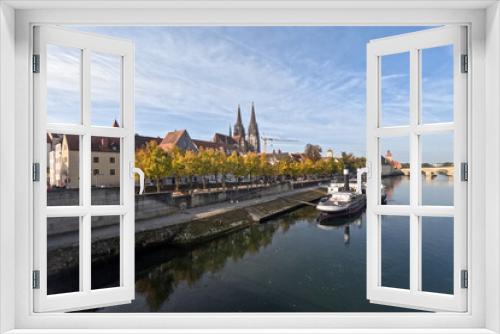 Regensburg on the Danube with stone bridge in sunshine and clouds in autumn