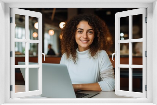 Photo of joyful nice woman using laptop. Beautiful Businesswoman typing on laptop.