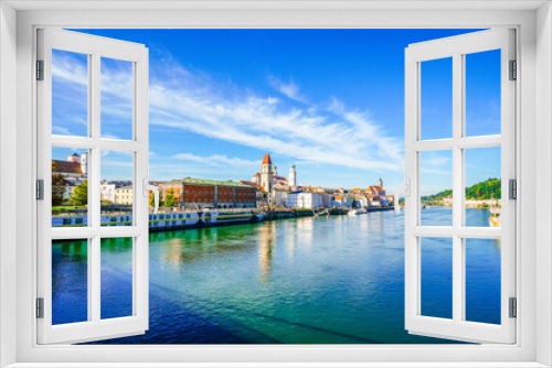 Fototapeta Naklejka Na Ścianę Okno 3D - View of some buildings and the surrounding landscape by the river in the city of Passau.
