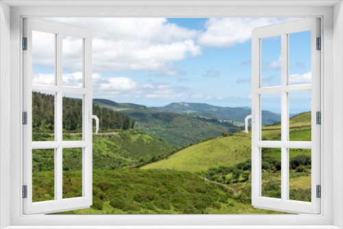 Green landscape of meadows and mountains with free cattle in Galicia